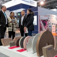 four persons are talking about the products in front of them four persons are talking about the products in front of them