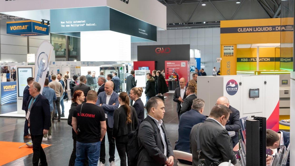 people standing in an exhibition hall surrounded by different booths people standing in an exhibition hall surrounded by different booths